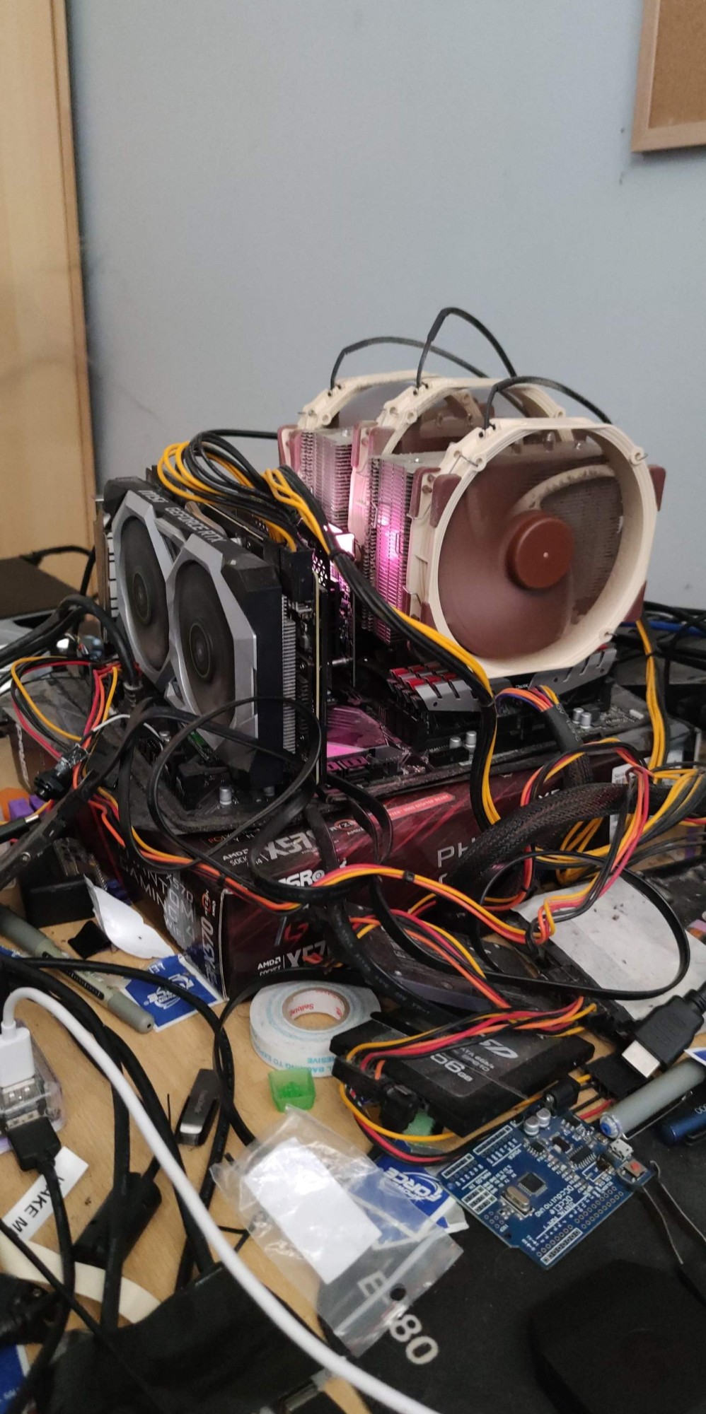 An absolute nest of cables and wires on a desk.
Picture of a computer built completely outside of its case